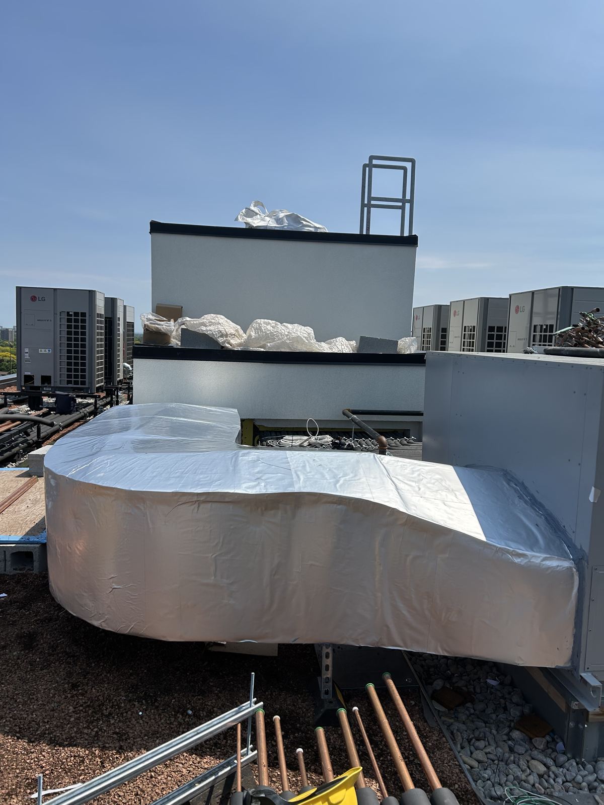 Curved rooftop duct run insulated and jacketed