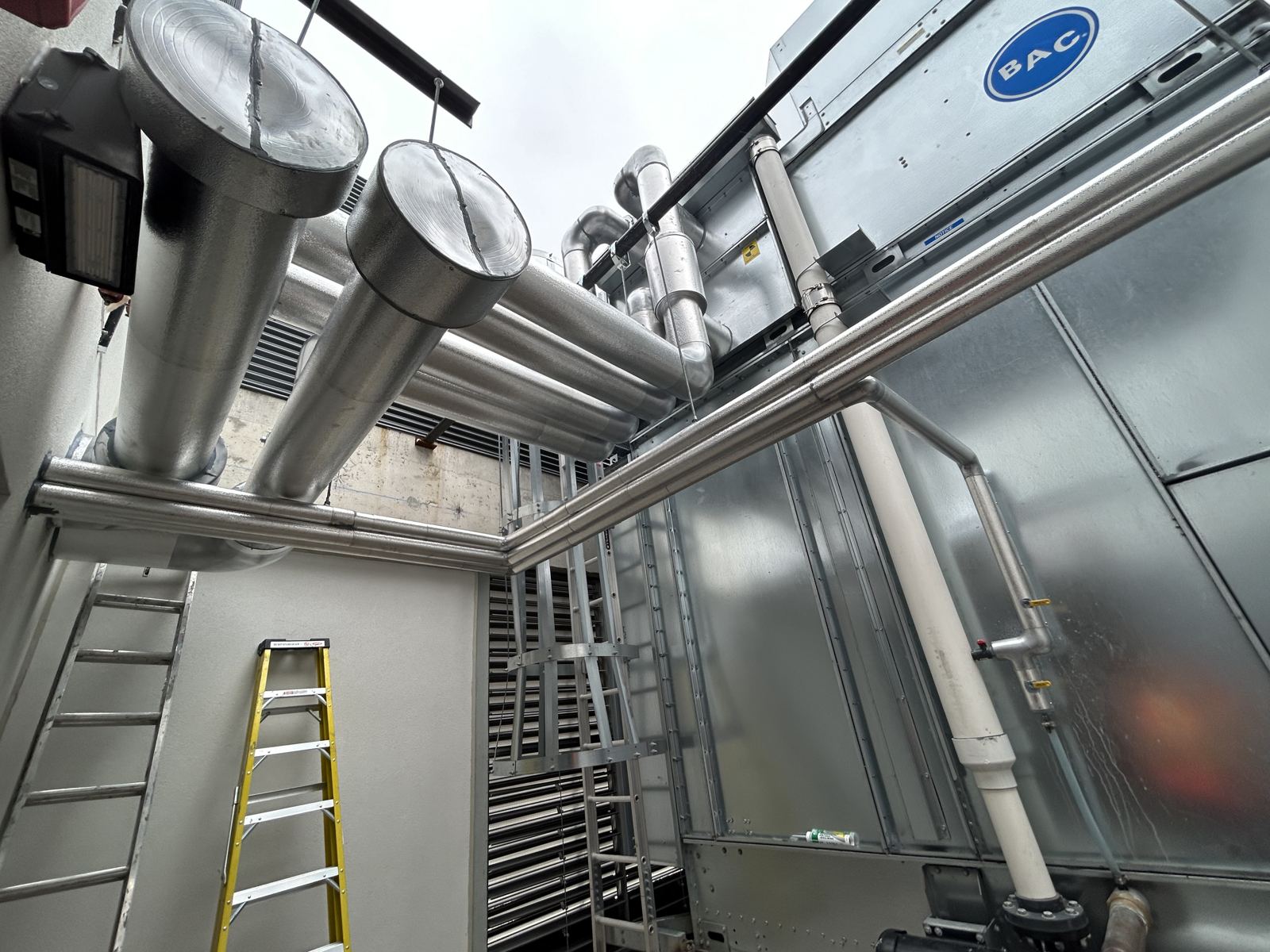 Insulated stacks beside a rooftop unit
